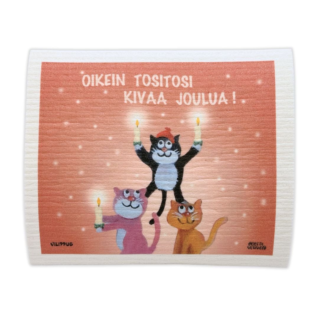 Kotimainen tiskirätti, jossa kuvitus kolmesta kissasta pyramidimuodostelmassa vaaleanpunaisella taustalla, sekä teksti "Oikein tositosi kivaa joulua!"