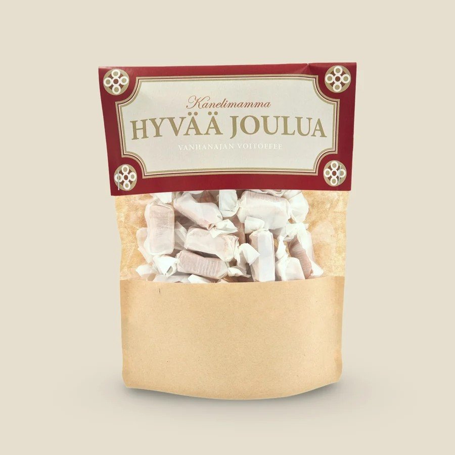 Voitoffee ruskeassa paperipussissa, jossa kartonkinen etiketti punaisella kehyksellä ja tekstillä "HYVÄÄ JOULUA"